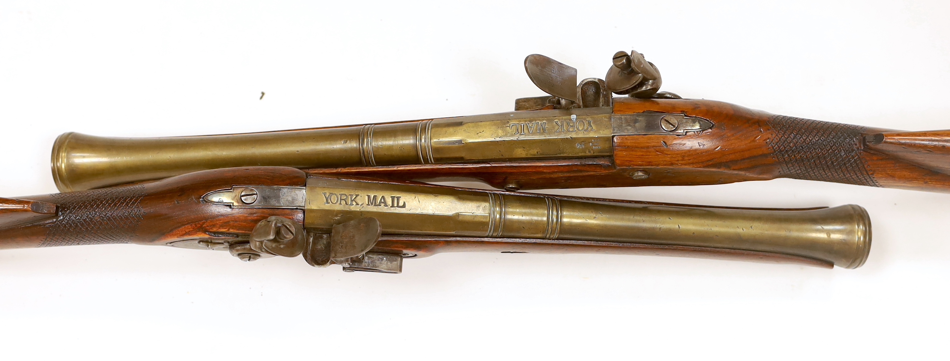 A pair of reproduction 'York Mail' flintlock blunderbusses in a late 18th century style.